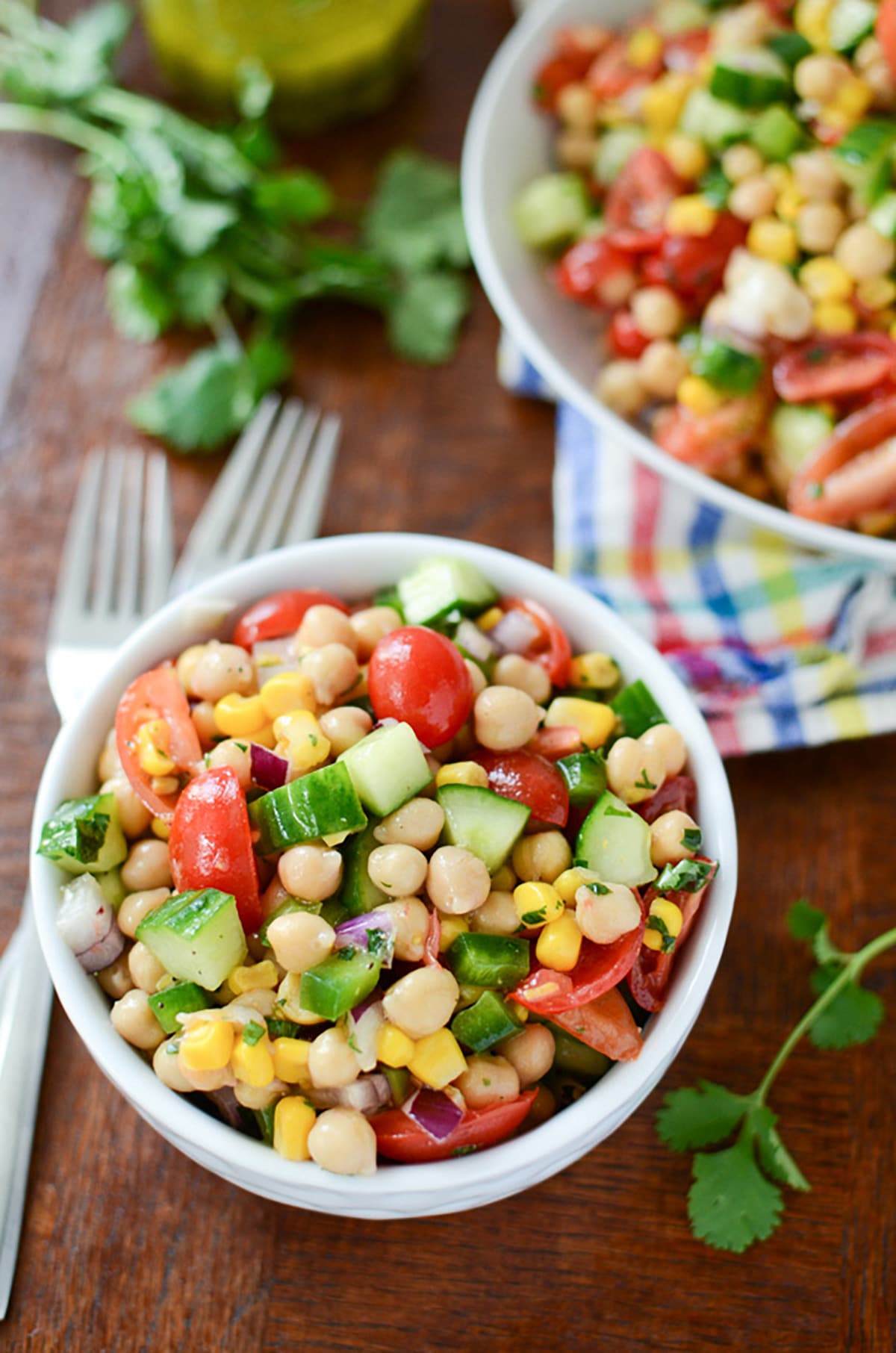 close-up top view of corn and garbanzo bean salad in a small white bowl