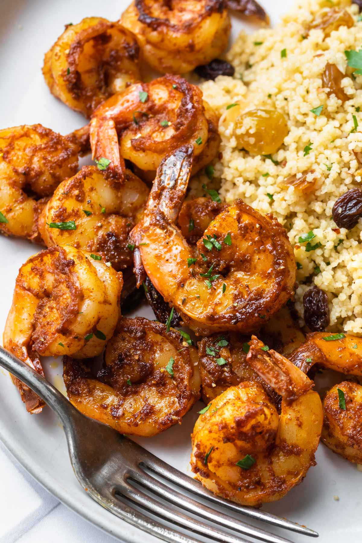 closeup of sweet spicy shrimp next to moroccan couscous