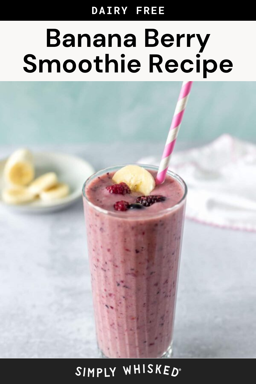 A tall glass of banana berry smoothie with a pink striped straw, garnished with banana and berries. A plate with banana slices is in the background. Text reads Dairy Free Banana Berry Smoothie Recipe, featuring a delicious and refreshing banana berry smoothie perfect for any time of day.