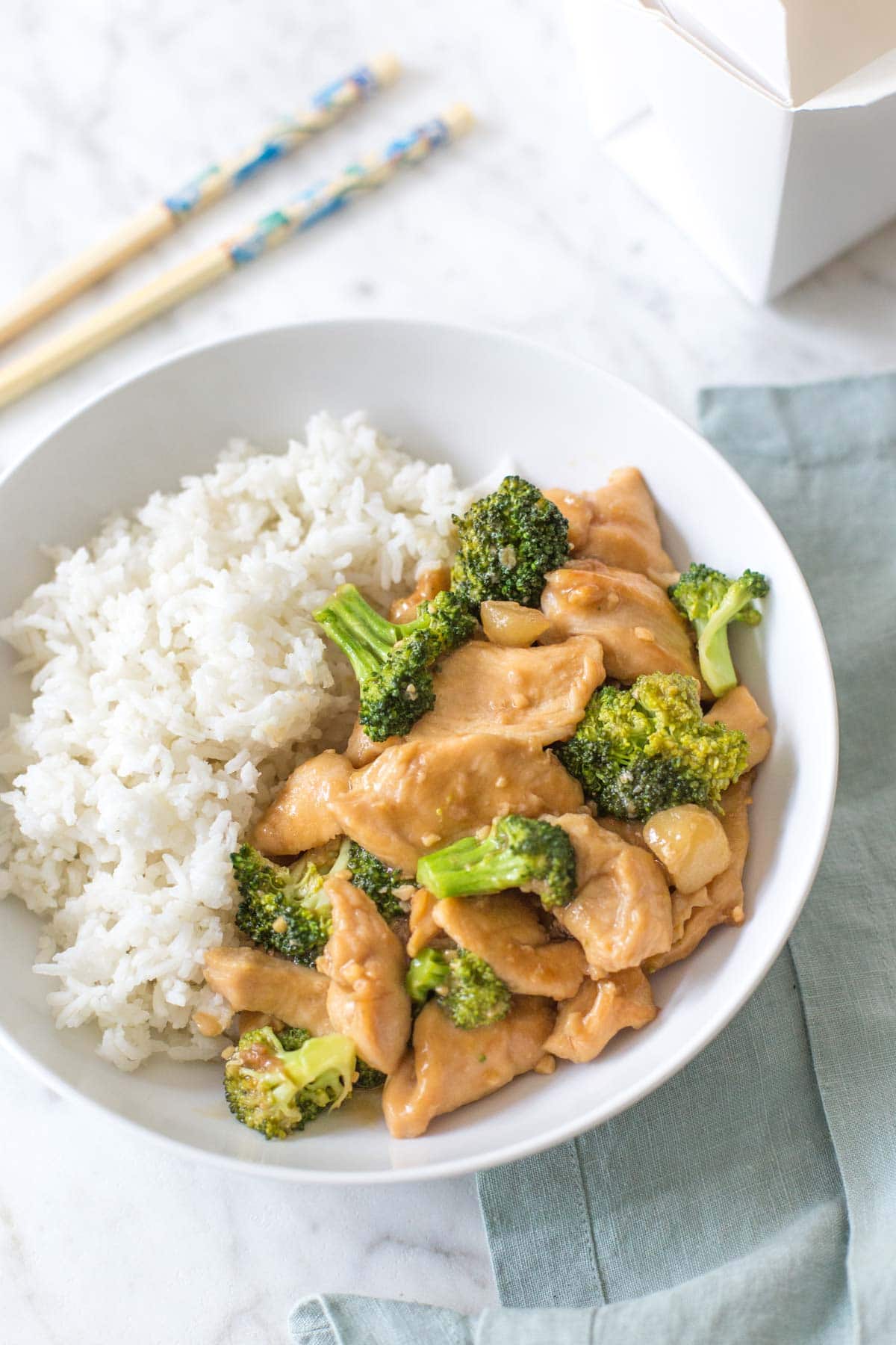 Chinese chicken and broccoli with white rice in a bowl. 