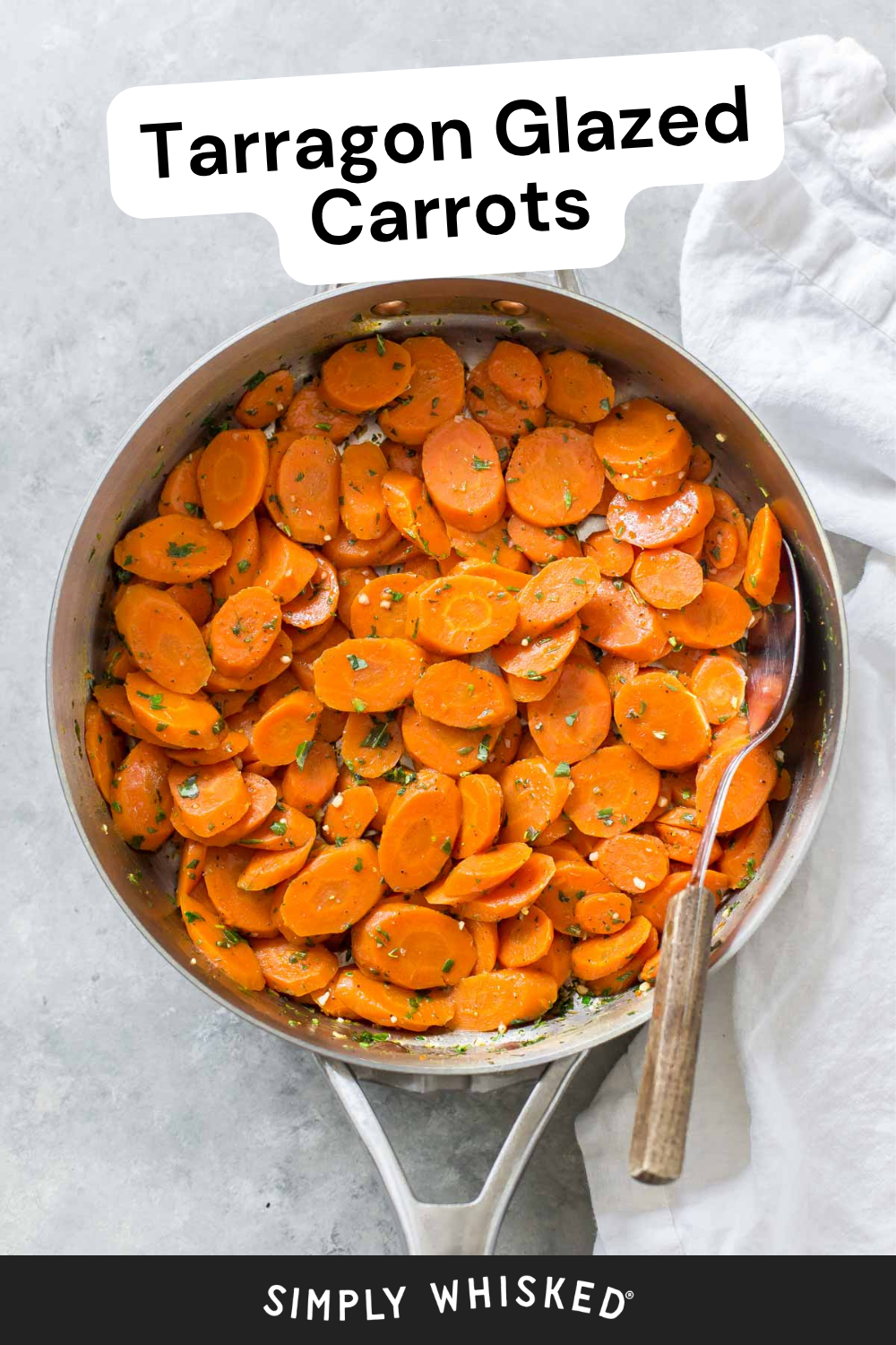 A pan filled with tarragon glazed carrots, sliced and garnished with fresh herbs, sits invitingly with a spoon resting inside. A white cloth is placed next to the pan. Text reads Tarragon Glazed Carrots at the top and Simply Whisked at the bottom.