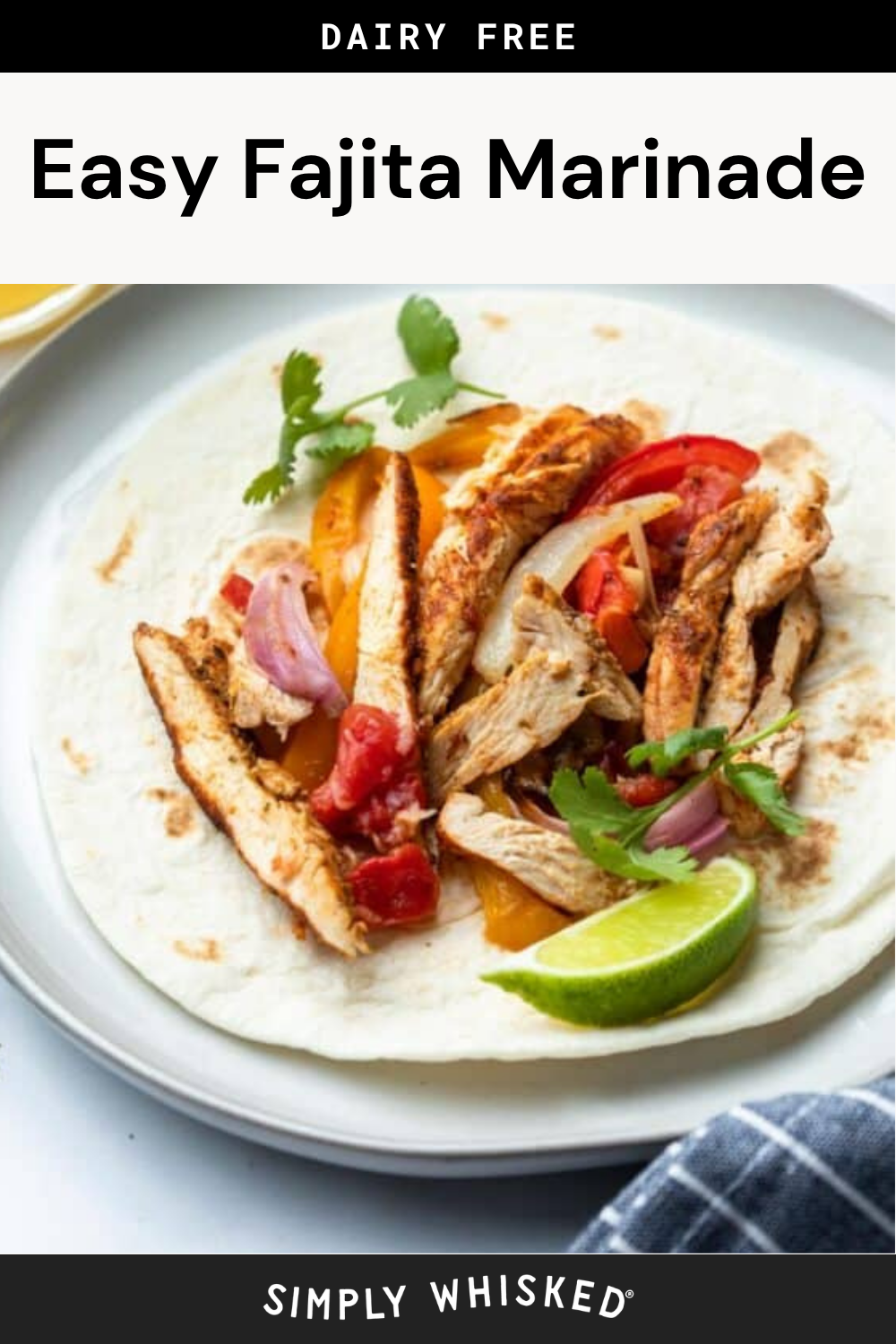 A tortilla filled with grilled chicken strips marinated in a zesty fajita marinade, bell peppers, onions, tomatoes, cilantro, and a lime wedge, served on a white plate. Text reads Easy Fajita Marinade and Dairy Free.