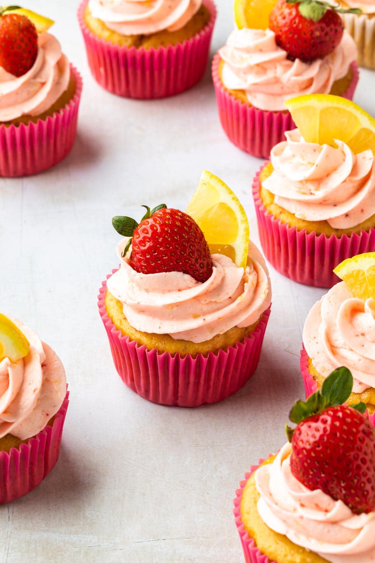 Strawberry lemonade cupcakes on a counter. 