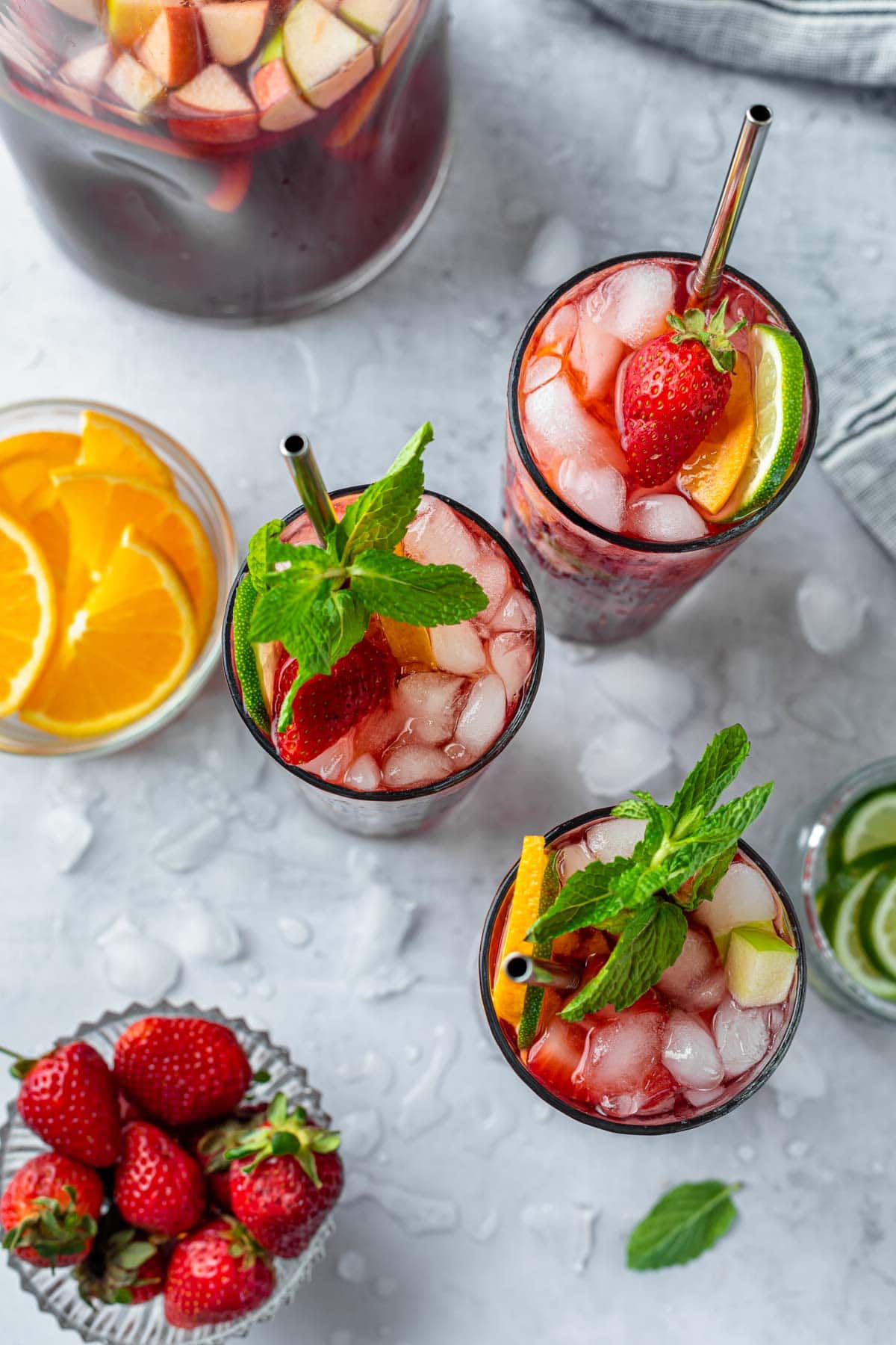 overhead of non alcoholic sangria in tall glasses with metal straws