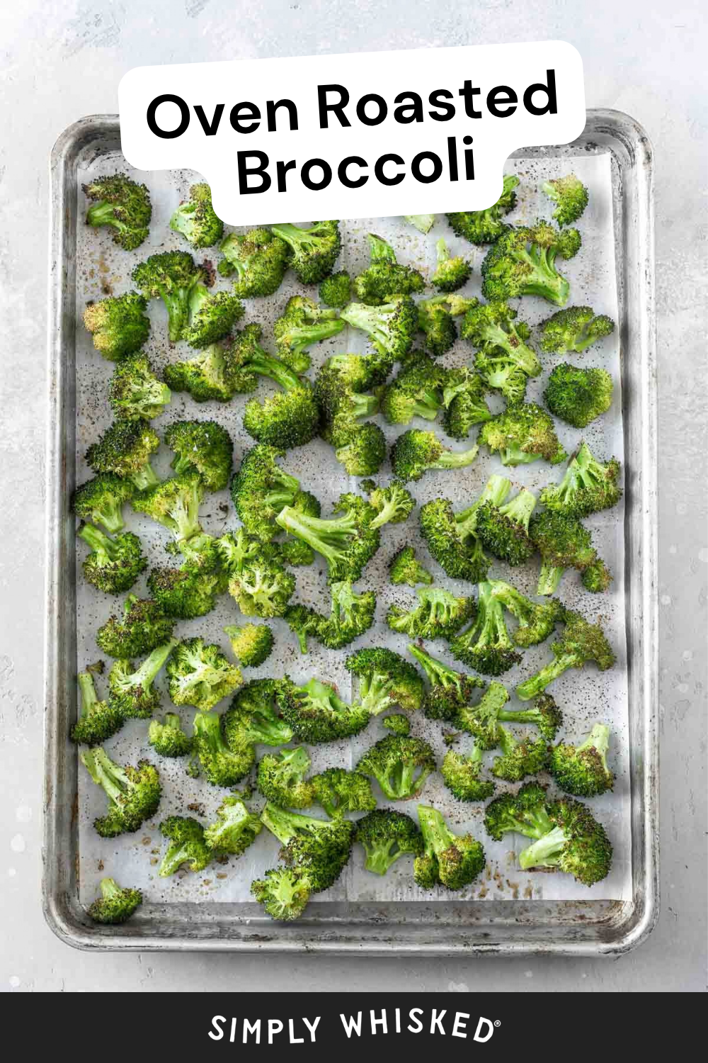 A baking sheet filled with oven roasted broccoli florets, evenly spread out. A label at the top reads Oven Roasted Broccoli. The bottom has the text Simply Whisked.