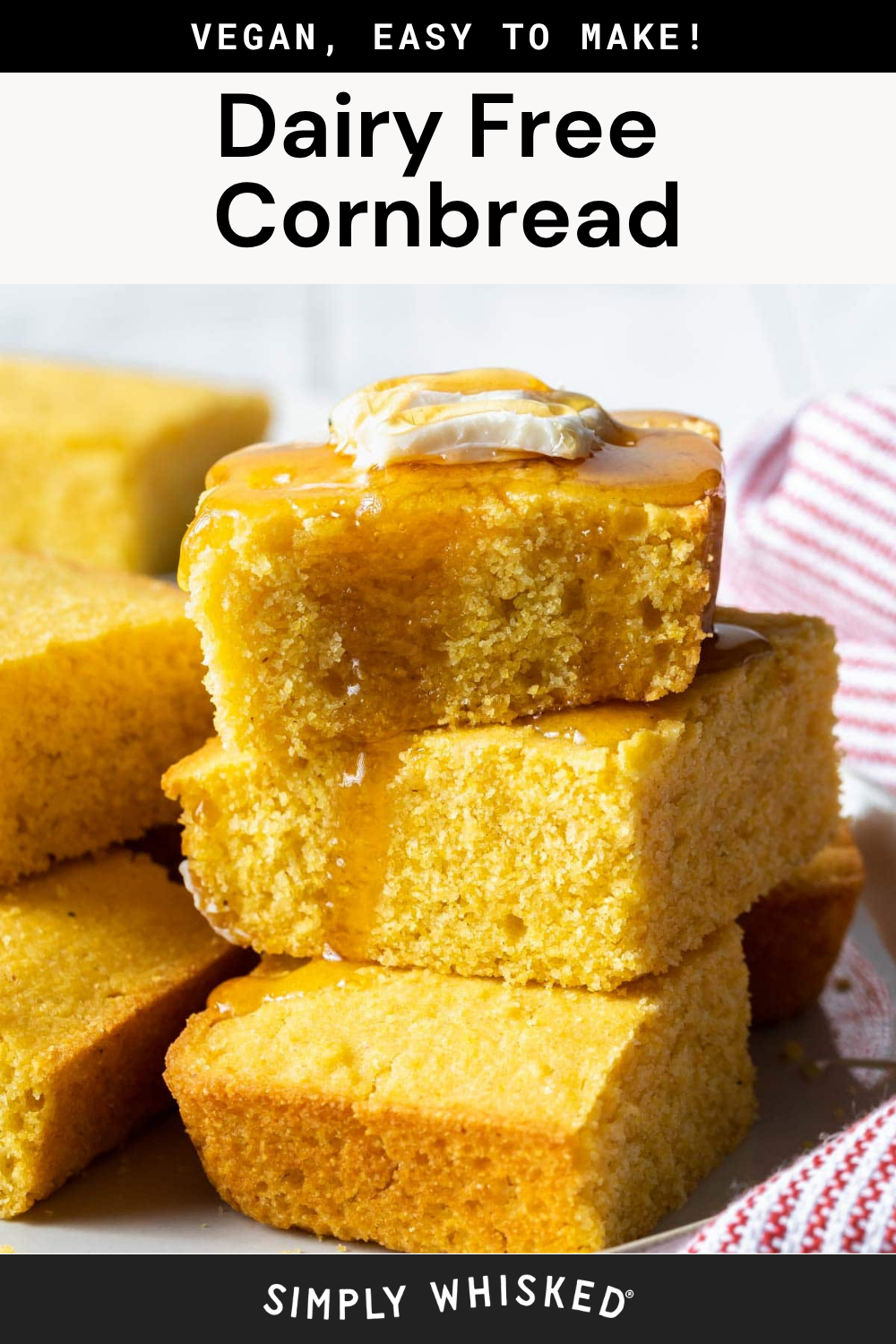 A stack of dairy free cornbread squares topped with vegan butter and syrup, with more dairy free cornbread pieces and a striped towel in the background.