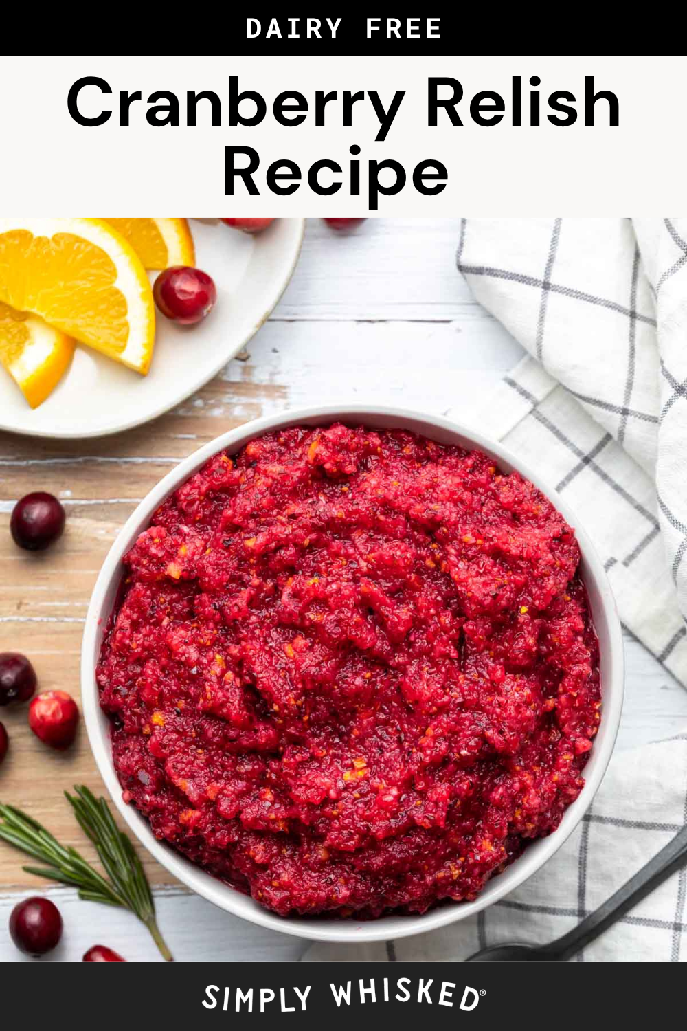 Bowl of cranberry relish on a white table with orange slices, cranberries, rosemary, and a checkered napkin nearby. Text above reads Dairy Free Cranberry Relish Recipe—an easy and flavorful cranberry relish perfect for any holiday table.