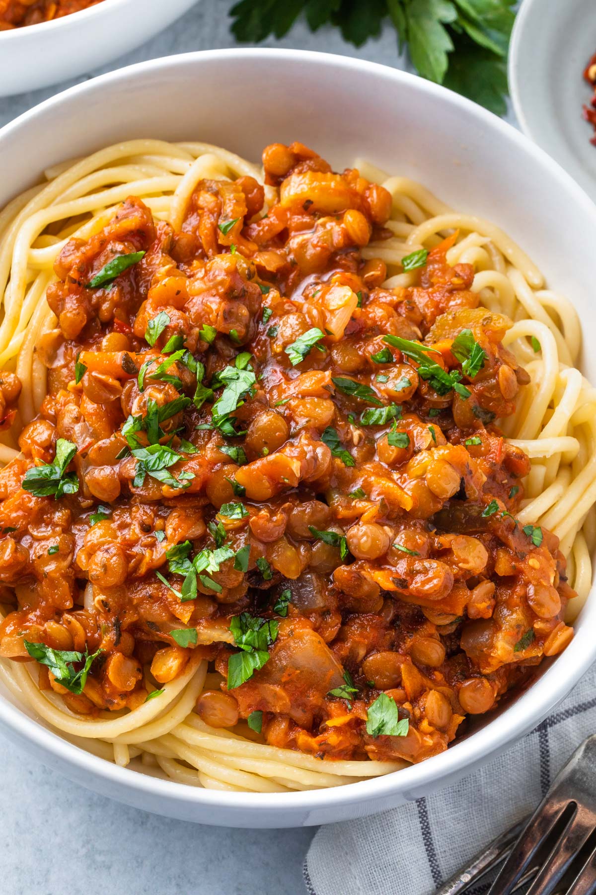 closeup of spaghetti topped with vegan bolognese sauce 