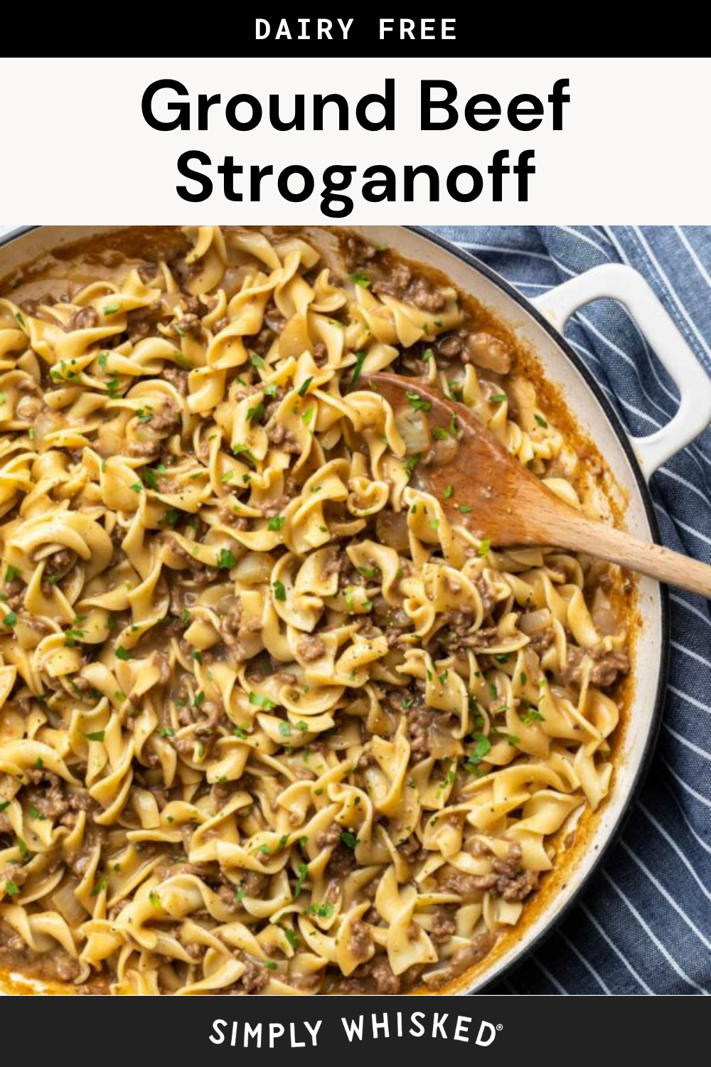 A skillet filled with creamy ground beef stroganoff made with tender egg noodles, garnished with chopped herbs, and a wooden spoon resting on the side. The text labels it as dairy free.