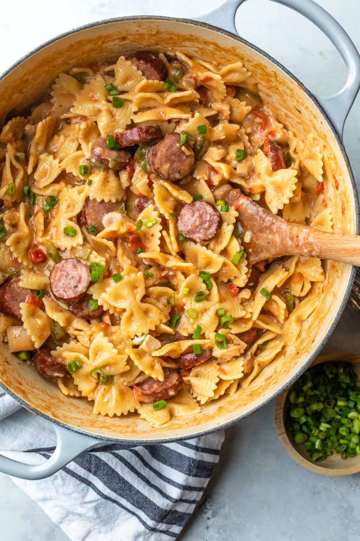 overhead of cajun pasta with chicken and smoked sausage in a cast iron pan