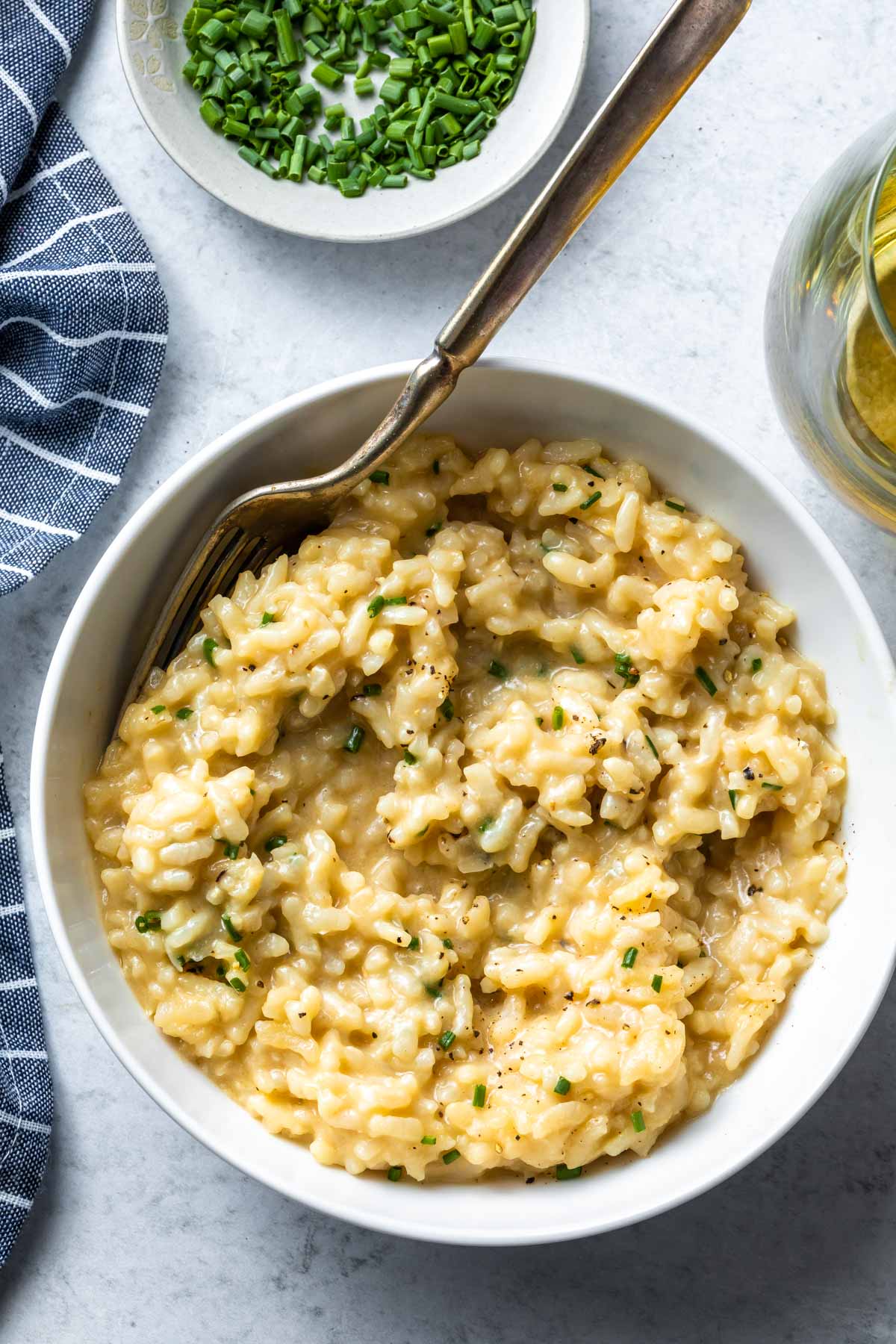 overhead view of vegan risotto in a bowl with a fork in it