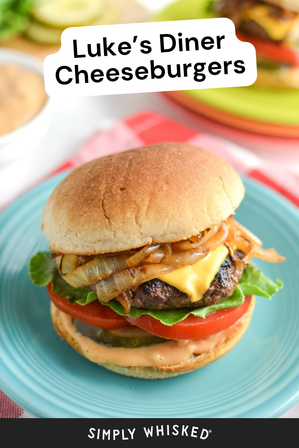 A classic diner burger, this cheeseburger features lettuce, tomato, pickles, grilled onions, and sauce on a blue plate. Text reads Lukes Diner Cheeseburgers and Simply Whisked.