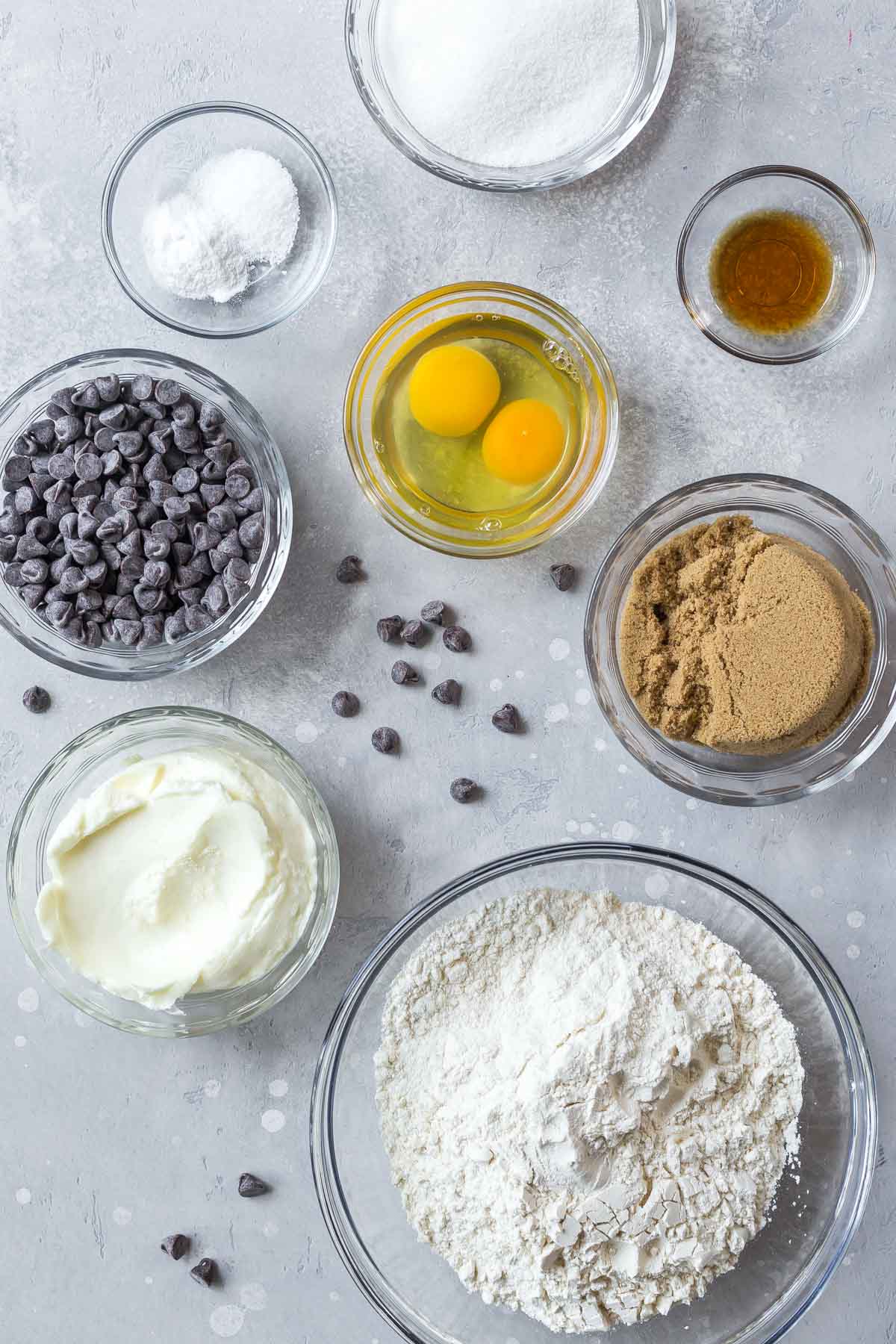 ingredients for dairy free chocolate chip cookies in various sizes of glass bowls