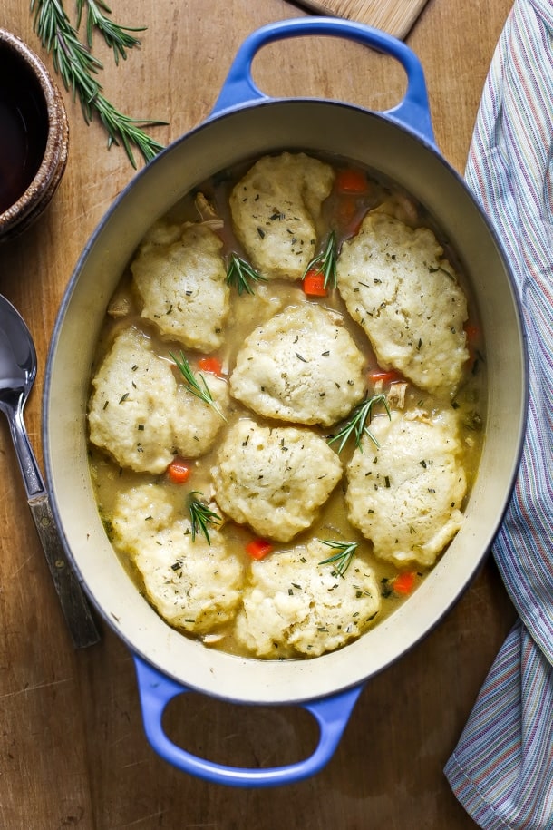 overhead view of chicken and dumpling soup in a large dutch oven a table top