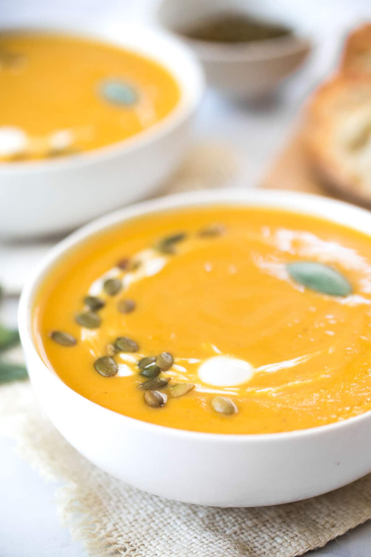 close up of squash soup in a white bowl