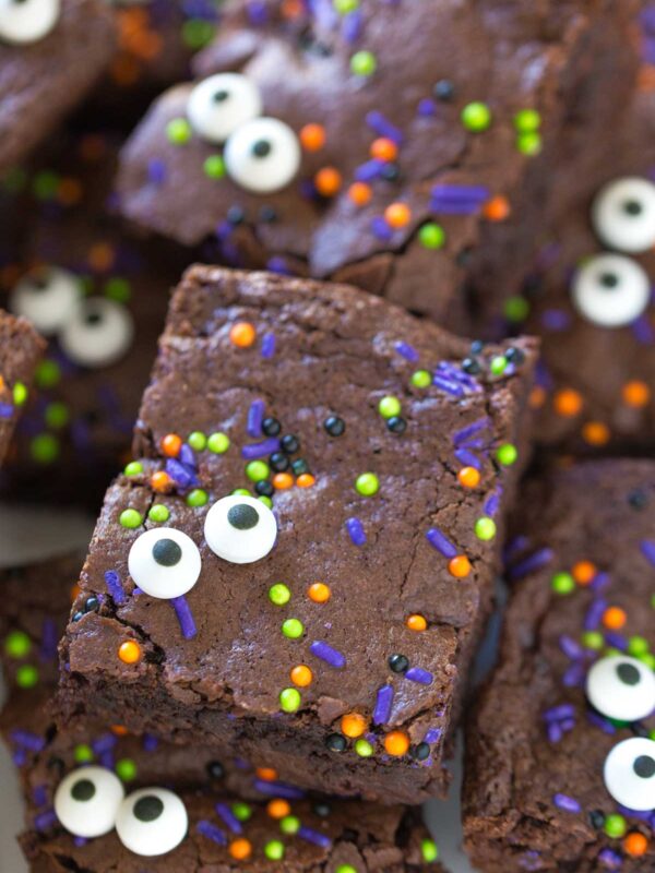 Halloween brownies decorated with colorful sprinkles and candy googly eyes create a playful, monster-themed treat perfect for any spooky celebration.