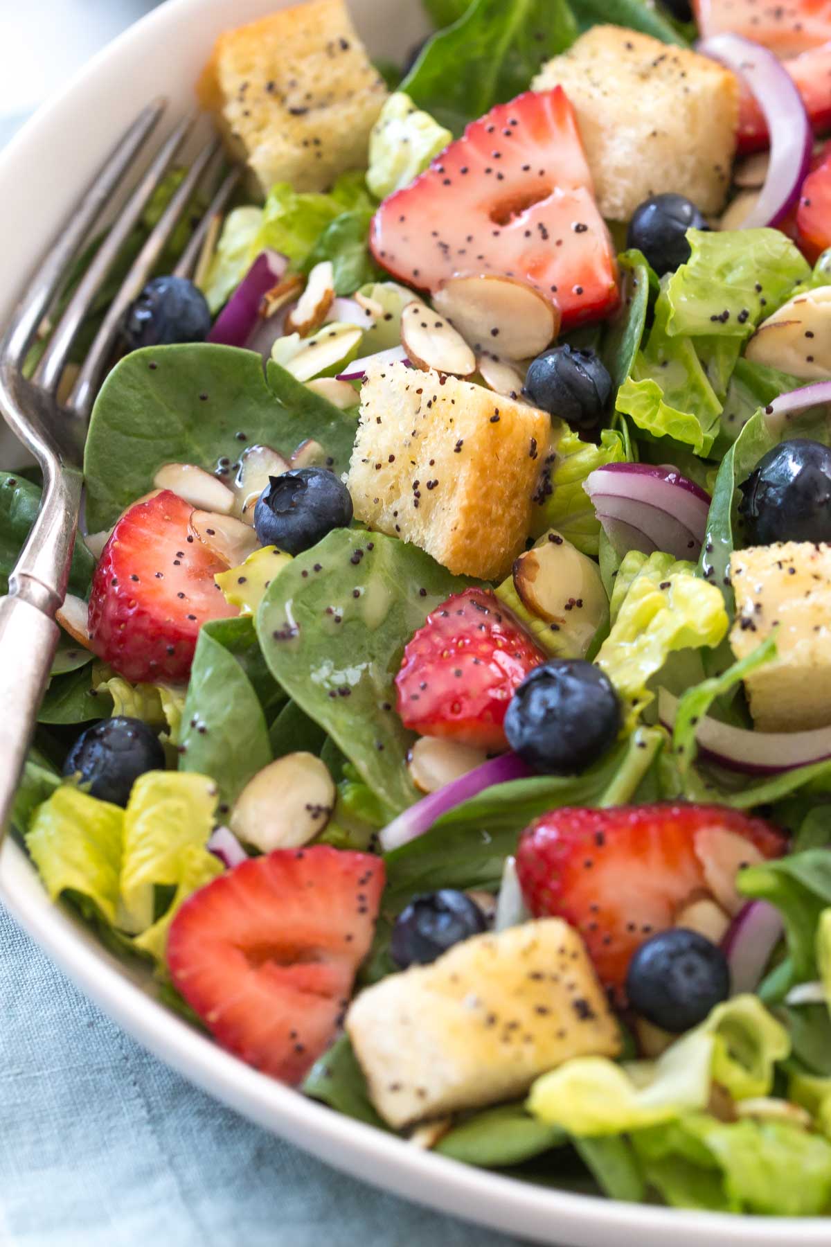 strawberry poppyseed salad with blueberries and croutons