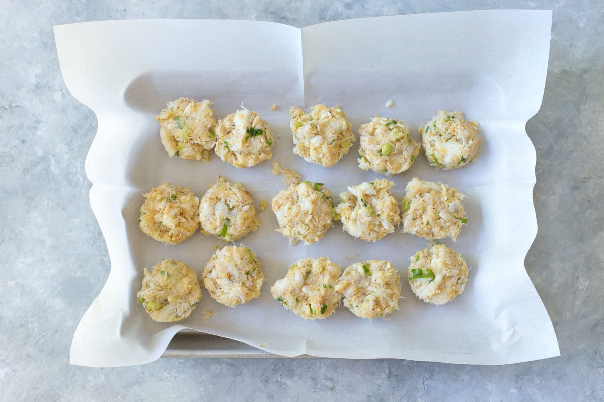 quarter sheet with uncooked fish cakes