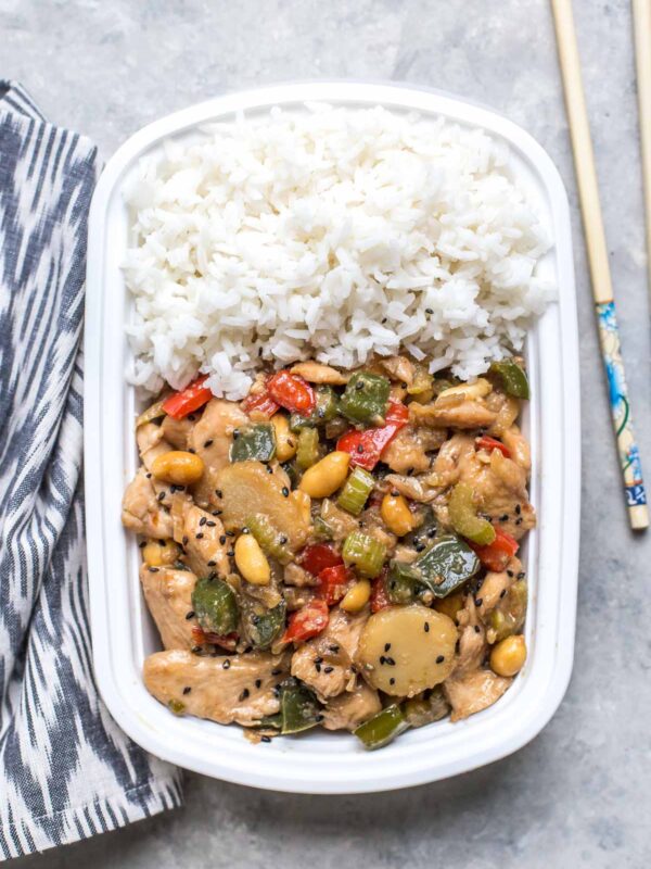 kung pao chicken with white rice in a takeout container