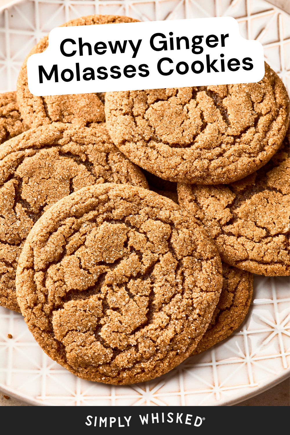 A plate of chewy ginger molasses cookies with a cracked surface, reminiscent of soft gingersnap cookies, placed on a white patterned dish. Text reads Chewy Ginger Molasses Cookies and Simply Whisked.