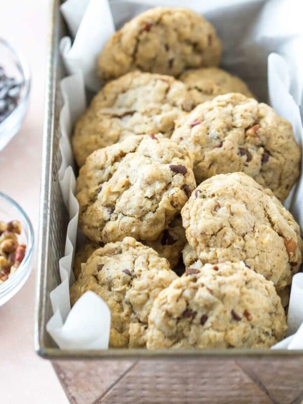 a vintage loaf pan holding a batch of vegan cowgirl cookies