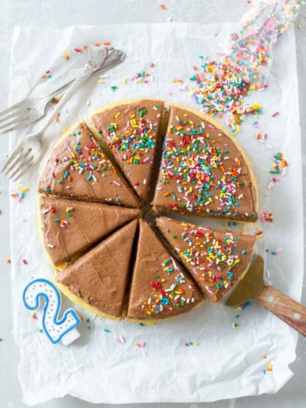 dairy free, one layer cake with chocolate buttercream frosting topped with sprinkles
