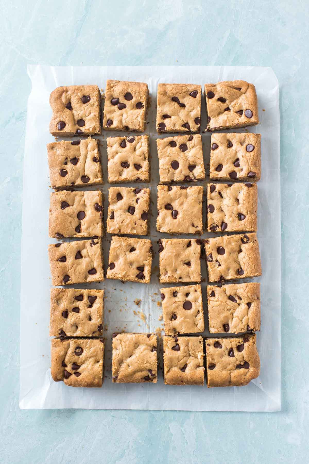 chocolate chip cookie bars on a piece of parchment paper