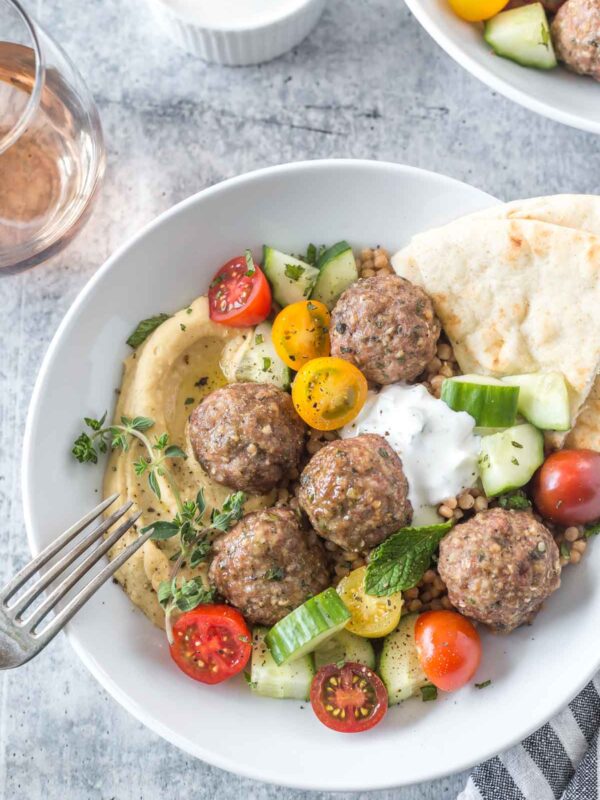 greek meatballs with hummus, couscous and vegan tzatziki sauce