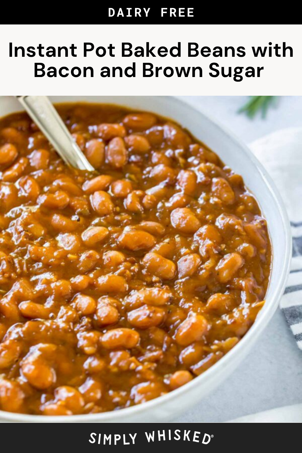 A white bowl filled with instant pot baked beans in sauce, featuring bacon and brown sugar, with a metal spoon inside. The dish is labeled as dairy free. A striped napkin is partially visible beside the bowl.