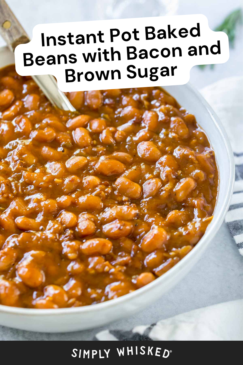 A bowl of instant pot baked beans with bacon and brown sugar sauce sits invitingly, a spoon ready in the dish. The words “Instant Pot Baked Beans with Bacon and Brown Sugar” appear above, while “Simply Whisked” graces the bottom.
