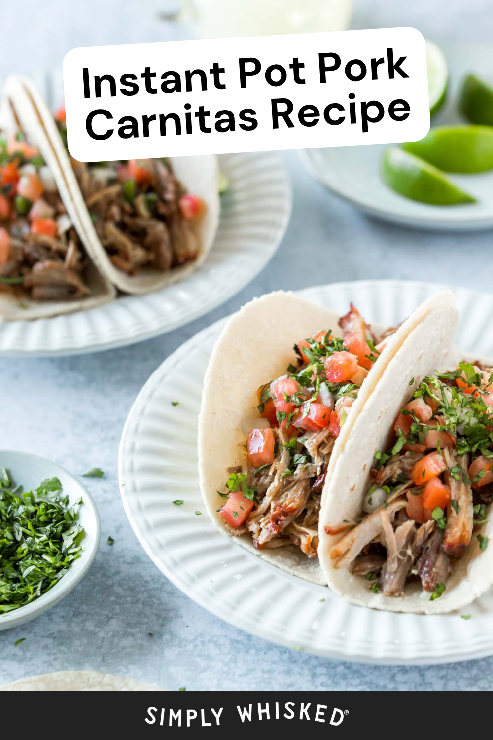 Two soft tacos filled with tender Instant Pot pork carnitas and fresh salsa sit on a white plate, garnished with cilantro. A small bowl of green herbs and lime wedges are in the background. Text says, Instant Pot Pork Carnitas Recipe.