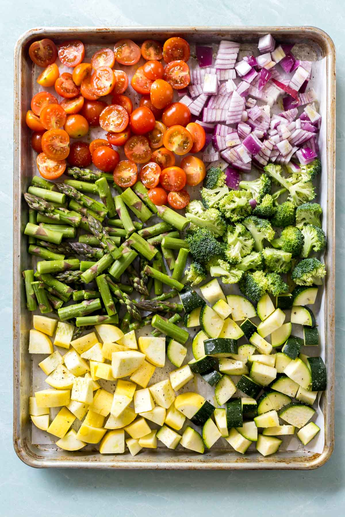 Summer vegetables on a cookie sheet before being cooked for roasted a vegetable pasta salad recipe