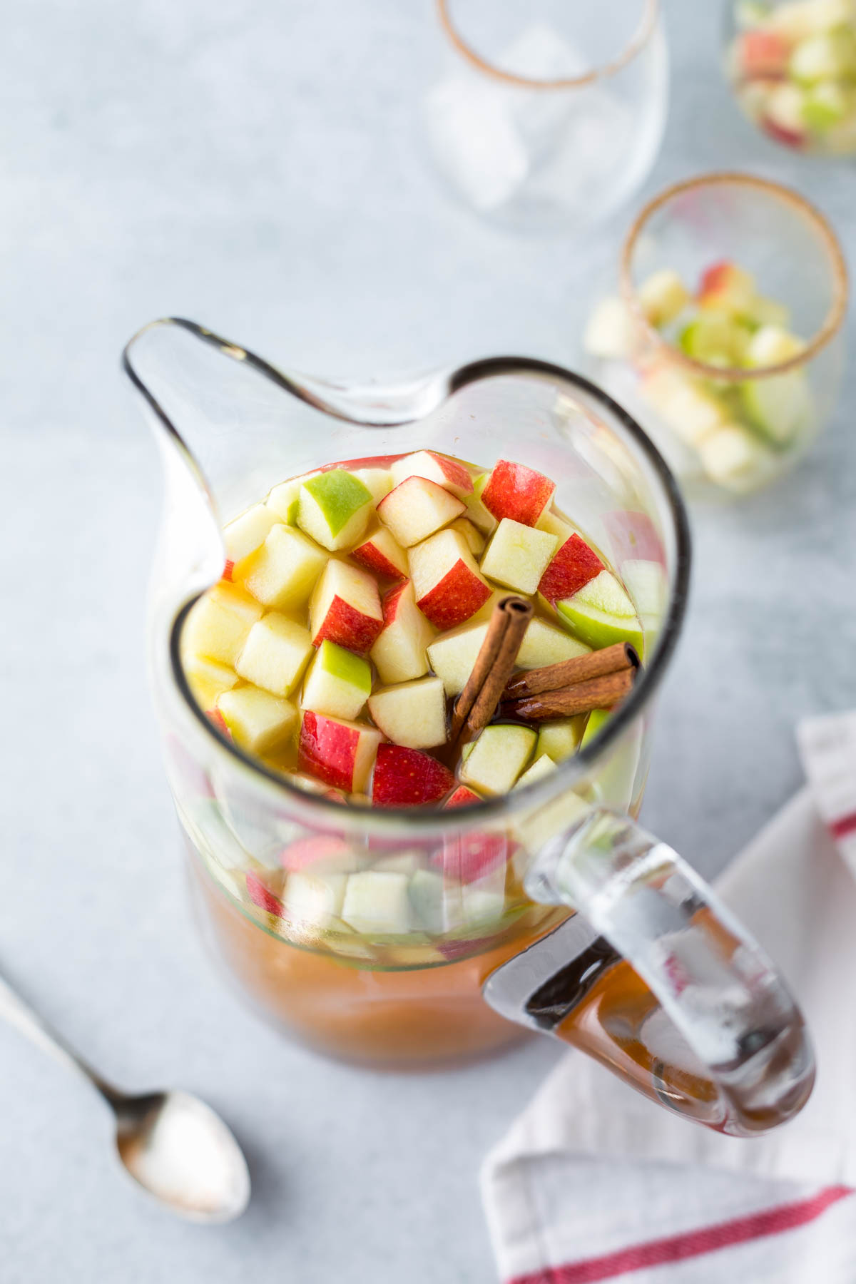 pitcher of sangria with apples and cinnamon sticks