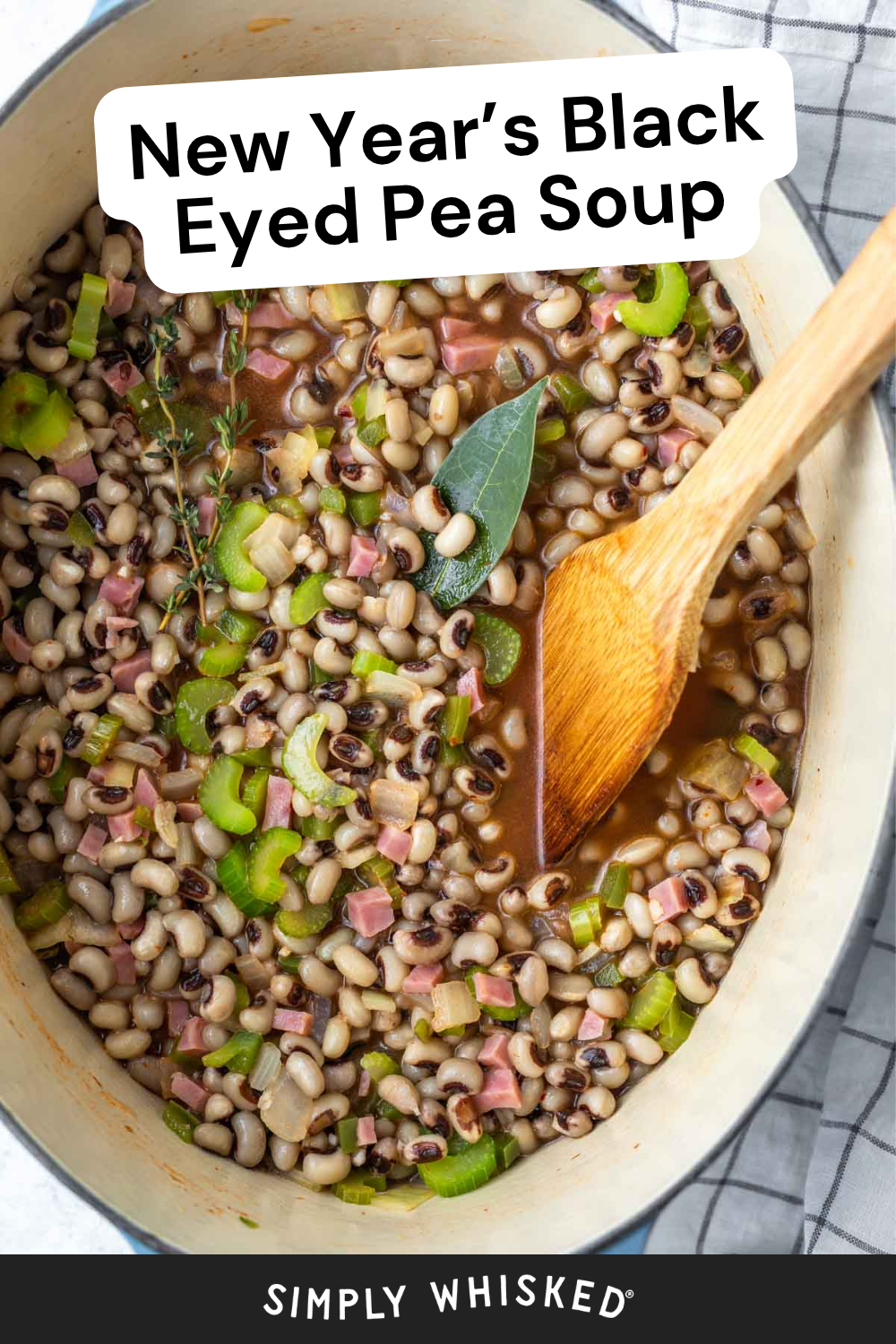 A pot of savory black eyed pea soup with celery, herbs, and diced ham, being stirred with a wooden spoon. The text reads, New Years Black Eyed Pea Soup.