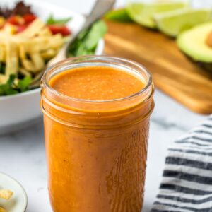 a small mason jar filled with Chipotle salad dressing