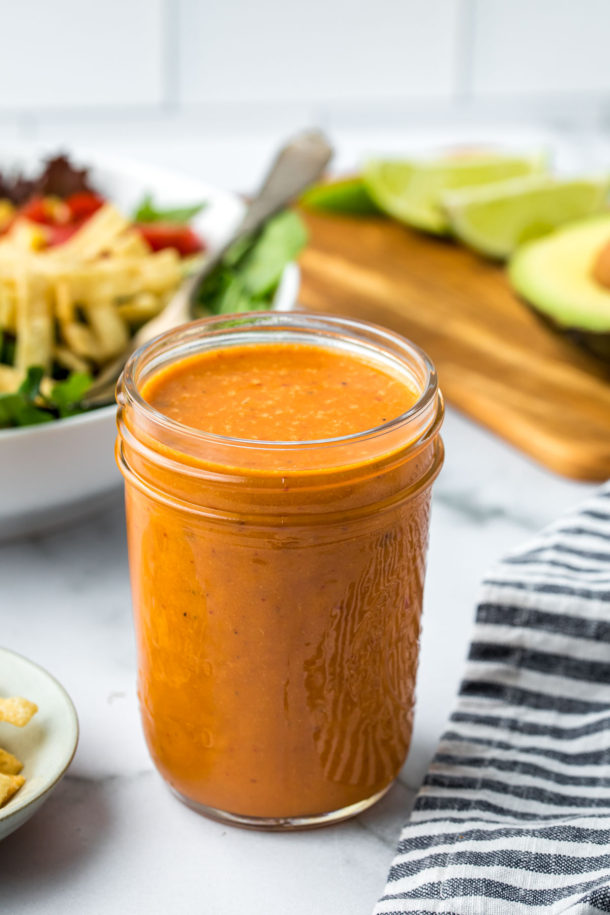 a small mason jar filled with Chipotle salad dressing