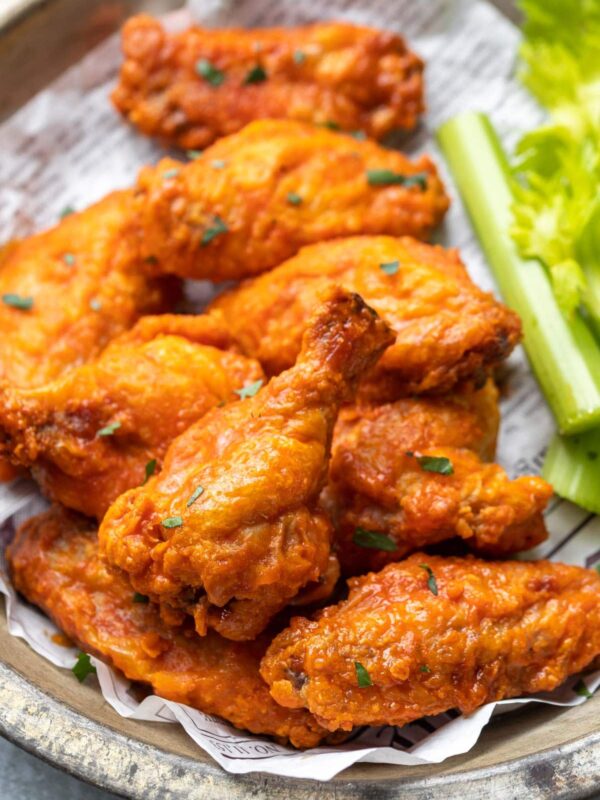 a close up view of a pile of chicken wings in a bowl
