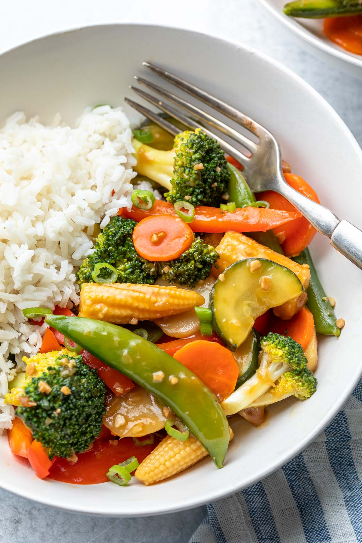 bowl of soy sauce covered veggies and white rice
