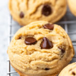 a close up of peanut butter chocolate chip cookies on a cooling sheet
