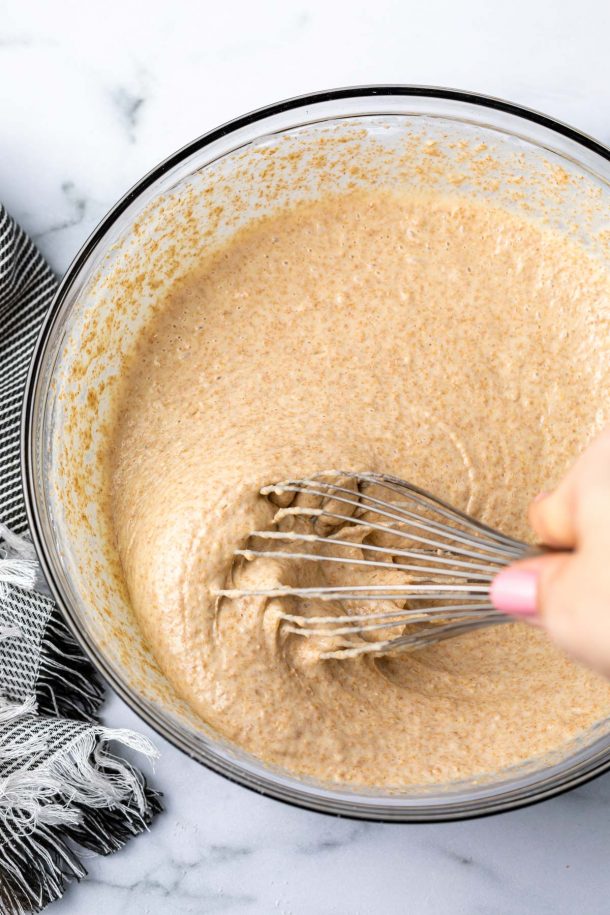 a whisk mixing up the pancake batter