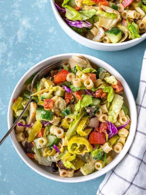 An aerial view of chopped Italian salad with a towel and bowl to the side