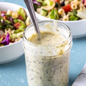 creamy italian dressing in a mason jar with a spoon