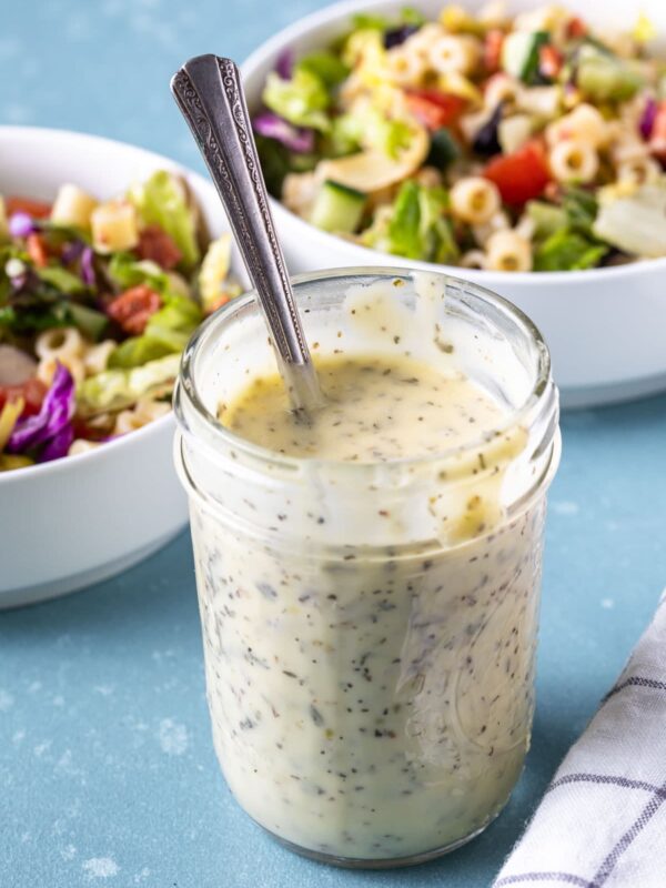 creamy italian dressing in a mason jar with a spoon