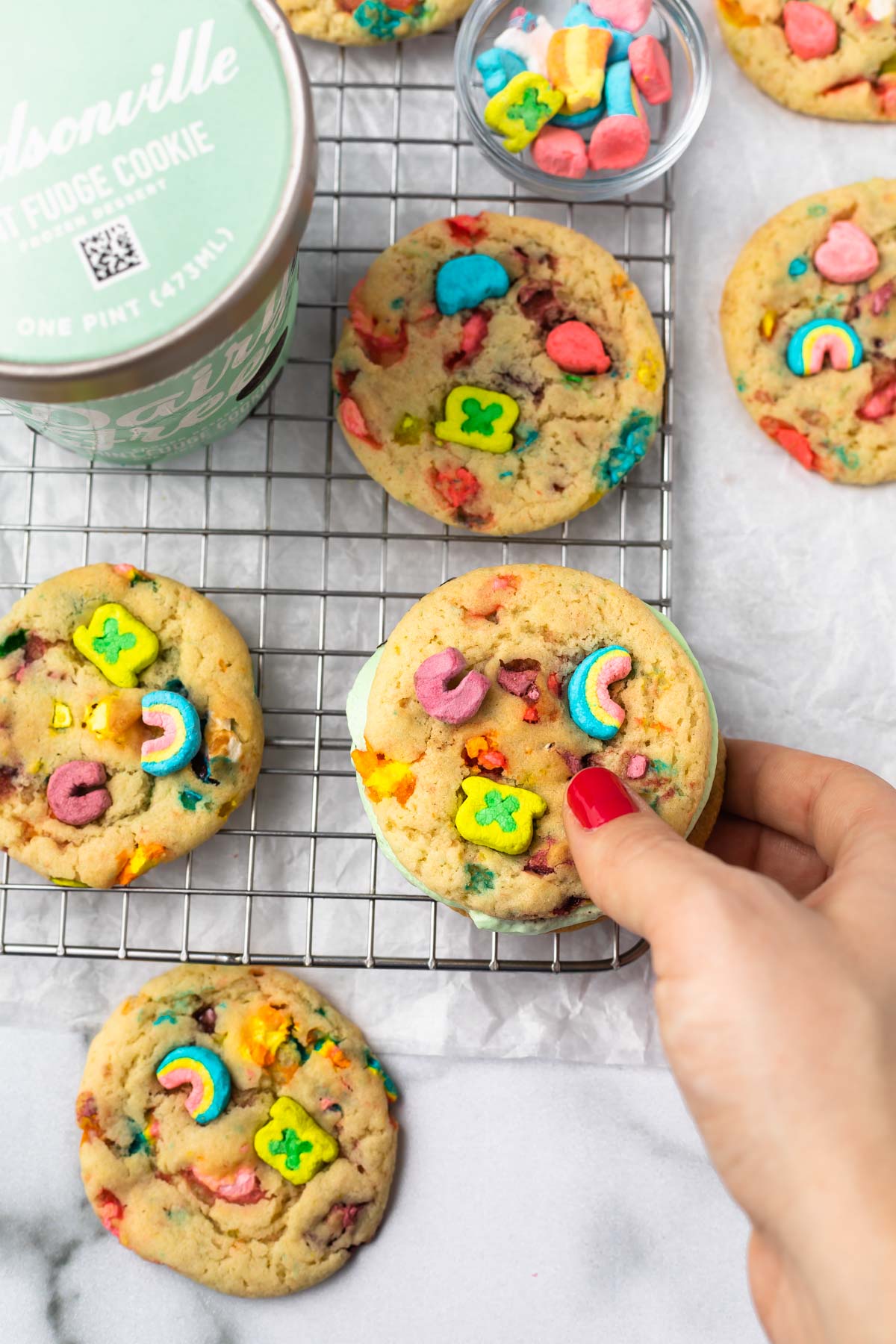 overhead photo of dairy free ice cream sandwiches made with lucky charms cookies on a cooling rack