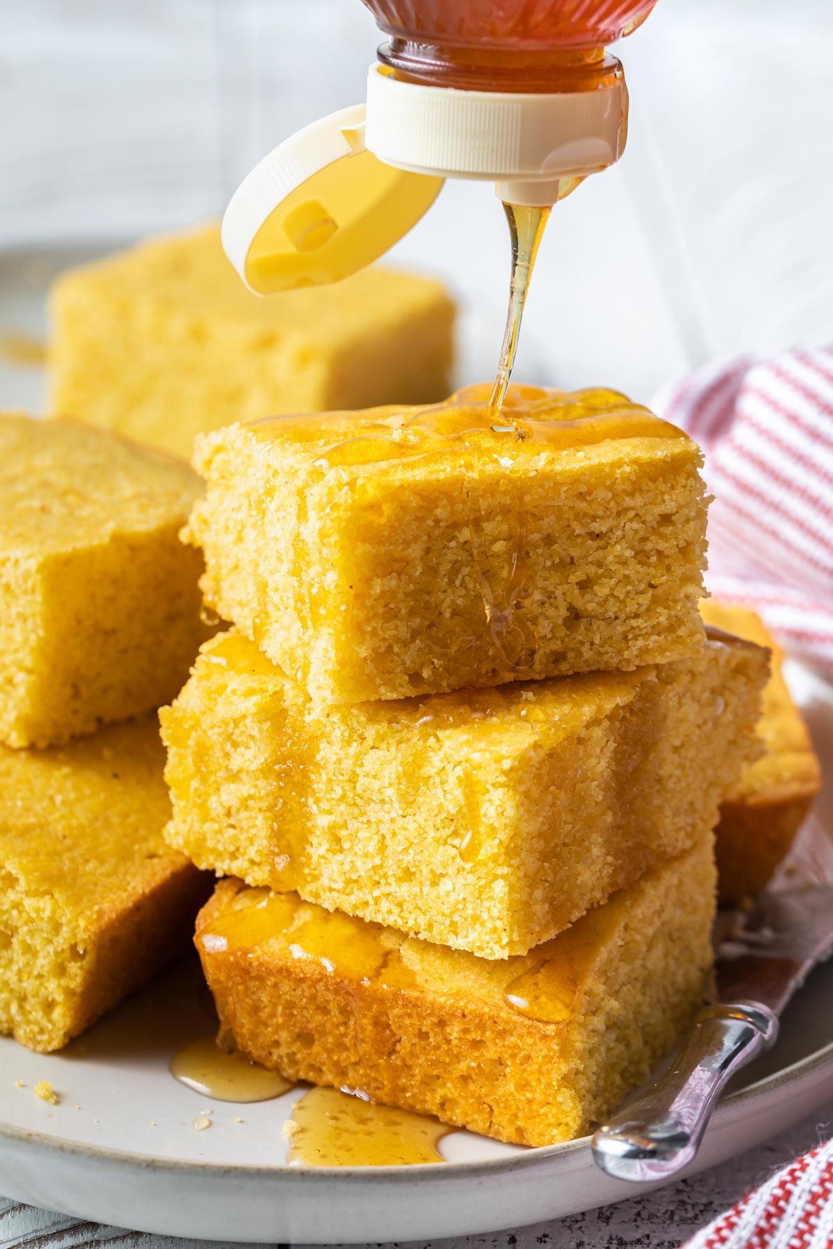 pouring honey over cornbread