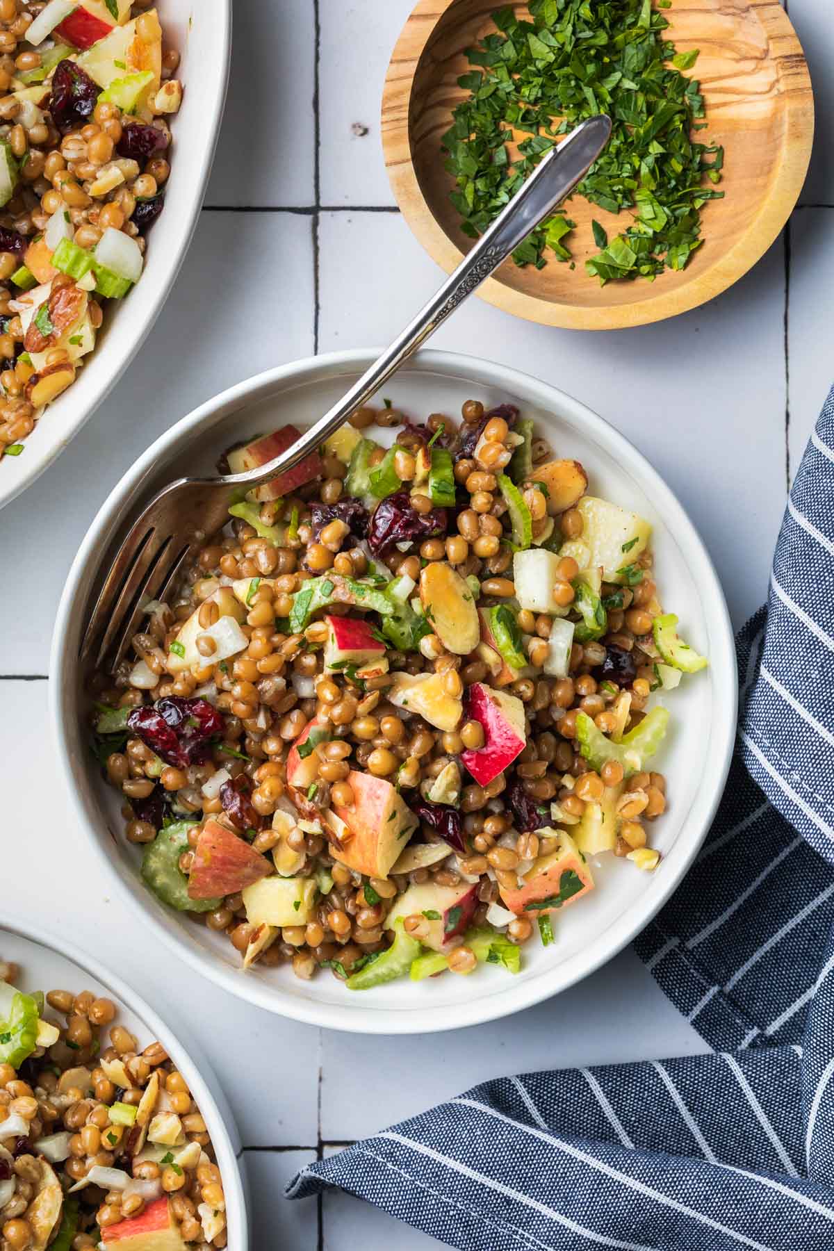 a bowl full of wheat berry salad with a fork