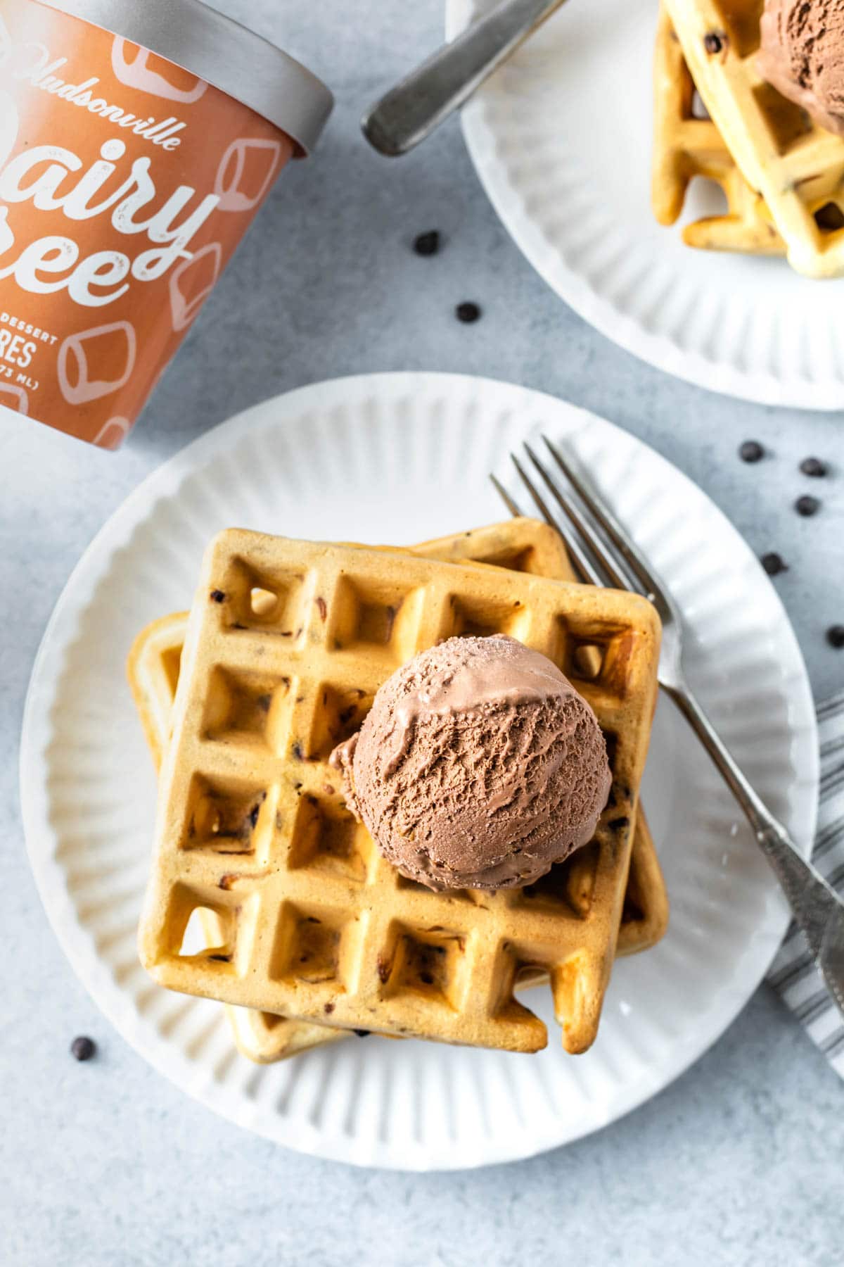 chocolate chip waffles topped with a scoop of dairy free ice cream