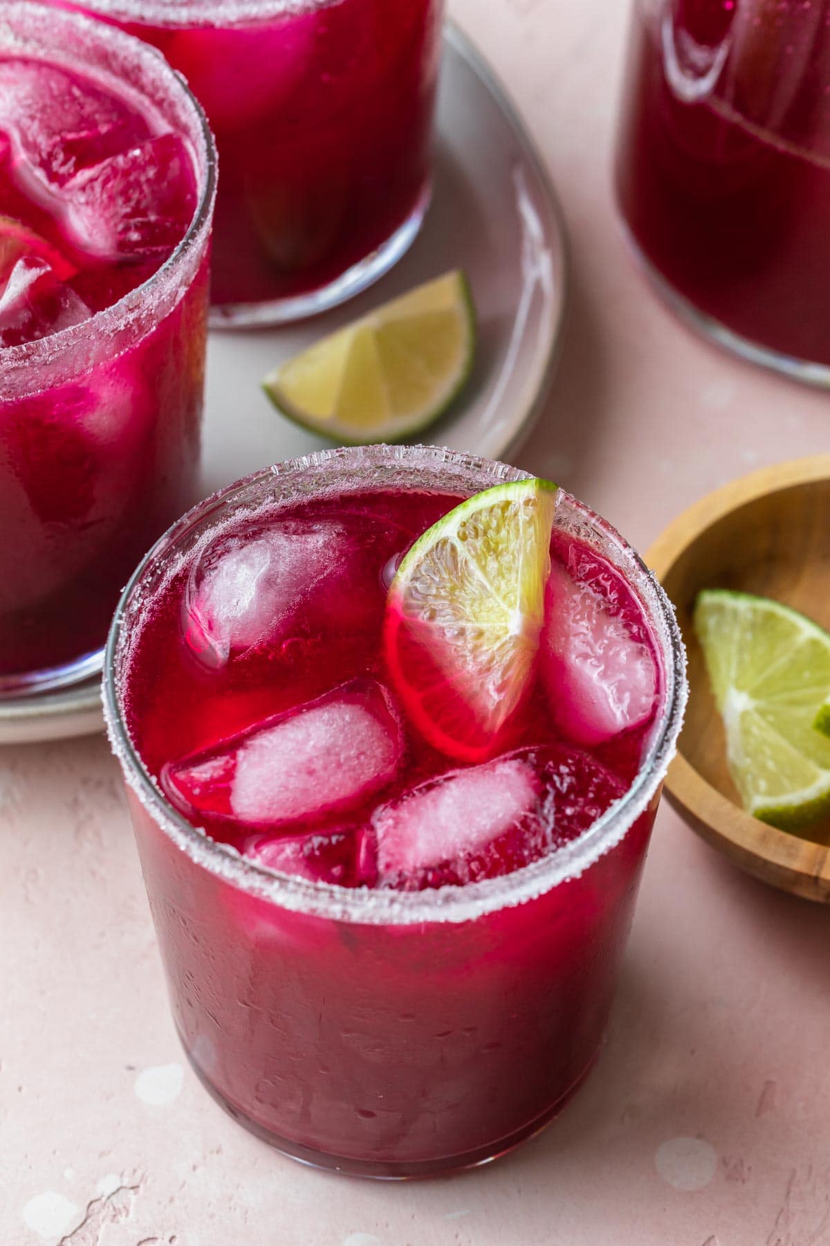 closeup of fresh prickly pear margaritas in a glass rimmed with sugar