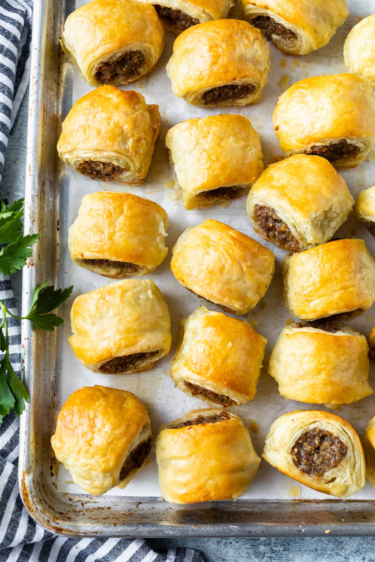 puff pastry sausage rolls on a baking sheet lined with parchment paper