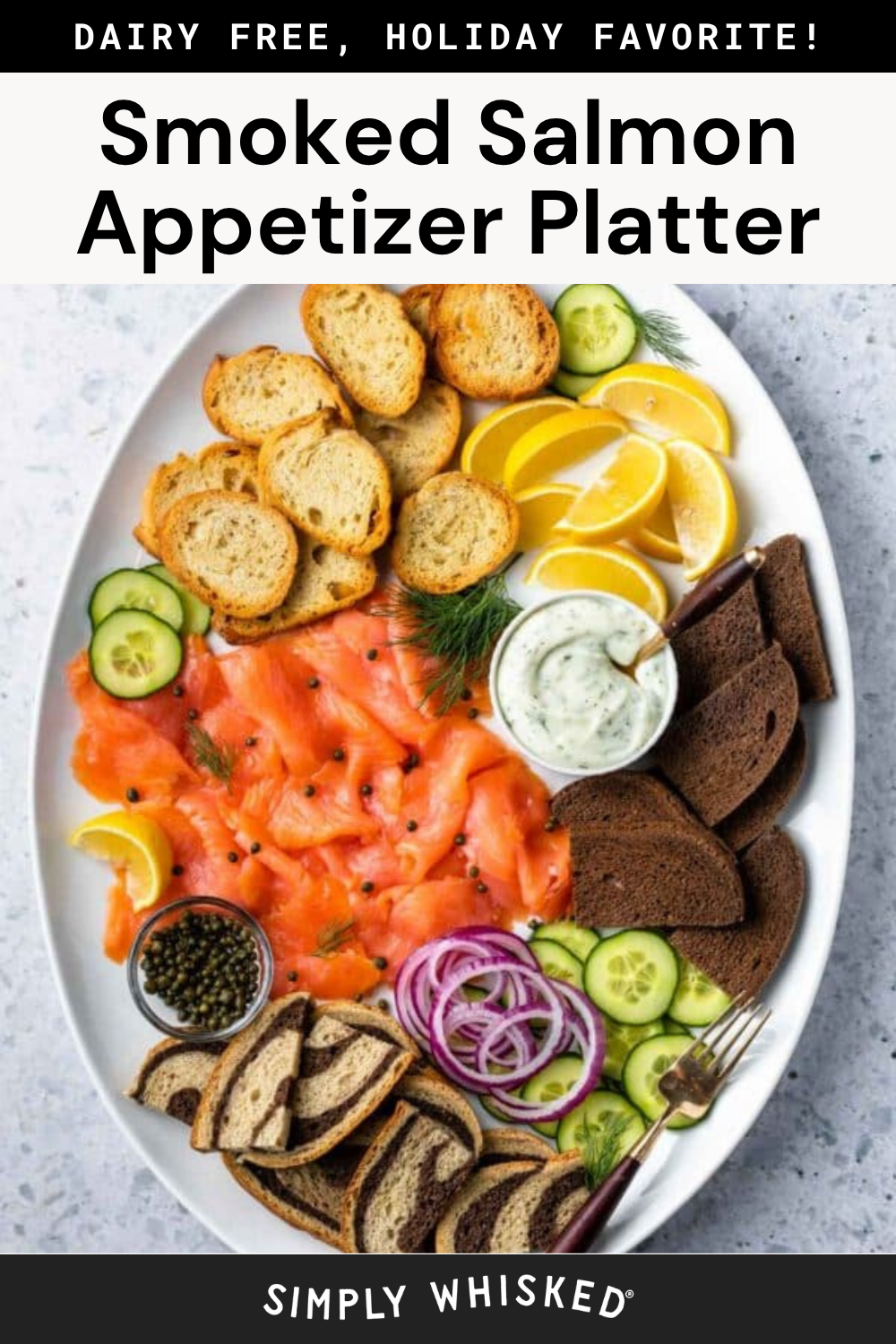 Oval platter with smoked salmon, cucumber, red onion, lemon wedges, capers, creamy dip, rye bread, and toasted baguette slices, all arranged neatly. Text above and below describes it as a dairy-free smoked salmon appetizer platter—perfect for your next holiday gathering.